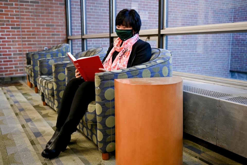 Aliya Bizhanova, a Michigan State University Ph.D. student, reads a book inside the Delia Kool International Academic Center on Wednesday, Nov. 3, 2021, on the MSU campus in East Lansing. Bizhanova is an international student from Kazakhstan.