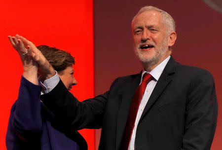 Britain's opposition Labour Party shadow foreign secretary, Emily Thornberry high fives with party leader Jeremy Corbyn after her speech at the Labour Party Conference in Brighton, Britain, September 25, 2017. REUTERS/Peter Nicholls