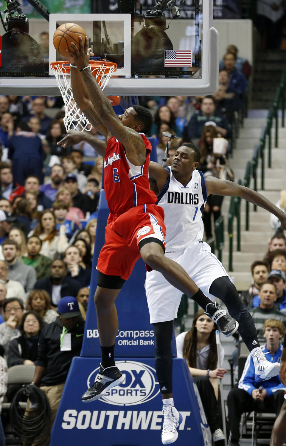 Los Angeles Clippers center DeAndre Jordan (6) grabs a rebound in front of Dallas Mavericks center Samuel Dalembert (1) during the first half of an NBA basketball game Friday, Jan. 3, 2014, in Dallas. The Clippers won 119-112. (AP Photo/Sharon Ellman)