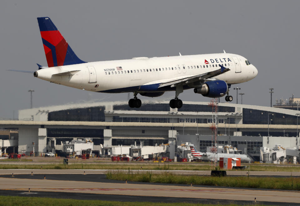 FILE - In this June 24, 2019, file photo a Delta Air Lines aircraft makes its approach at Dallas-Fort Worth International Airport in Grapevine, Texas. Delta Air Lines reports earns Tuesday, Oct. 8. (AP Photo/Tony Gutierrez, FIle)