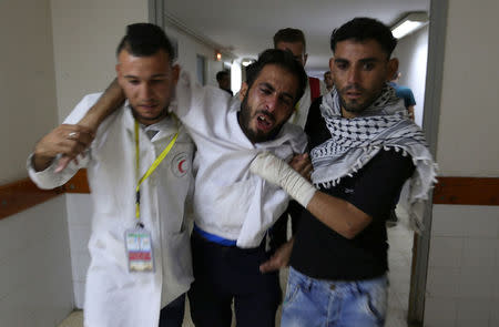 A colleague of Palestinian nurse Razan Al-Najar, who was killed during a protest at the Israel-Gaza border, reacts at a hospital in the southern Gaza Strip June 1, 2018. REUTERS/Ibraheem Abu Mustafa