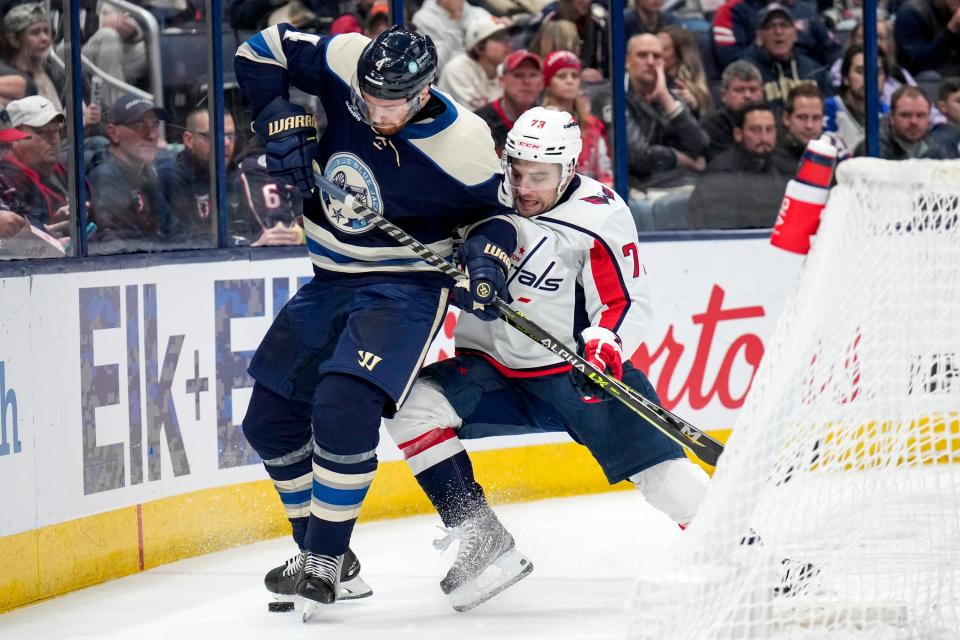 Jan 5, 2023; Columbus, Ohio, USA;  Columbus Blue Jackets defenseman Vladislav Gavrikov (4) fights with Washington Capitals left wing Conor Sheary (73) for control of the puck during the second period of the NHL game between the Columbus Blue Jackets and the Washington Capitals on Thursday night at Nationwide Arena. Mandatory Credit: Joseph Scheller-The Columbus Dispatch