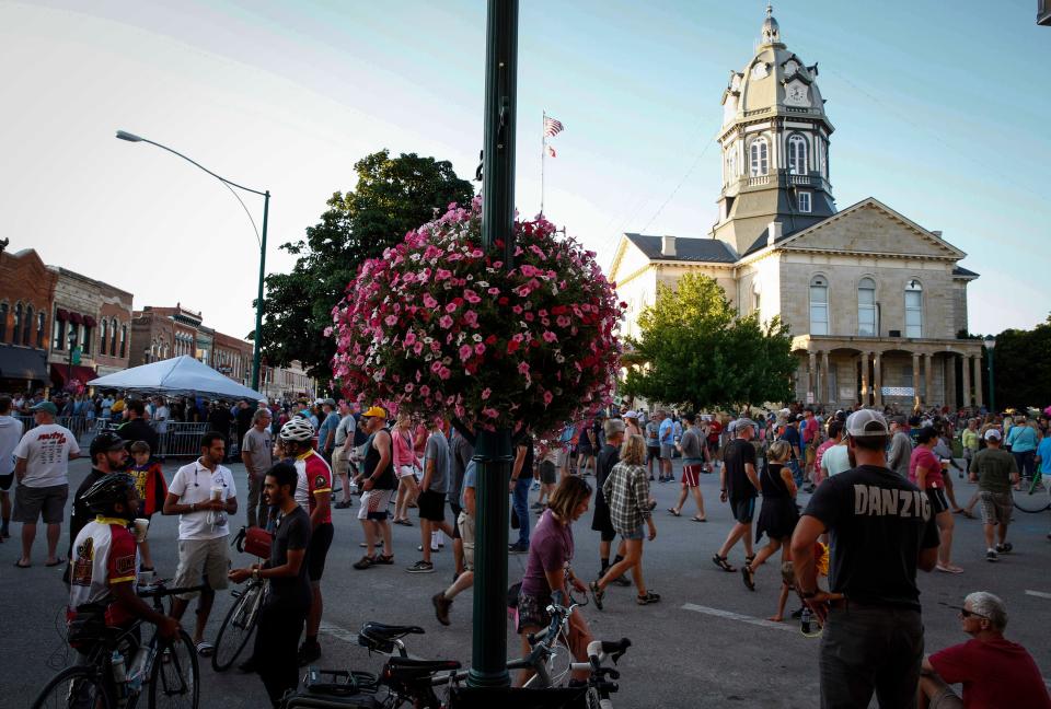 Cyclists mingle in the town square in Winterset during RAGBRAI on July 22, 2019.