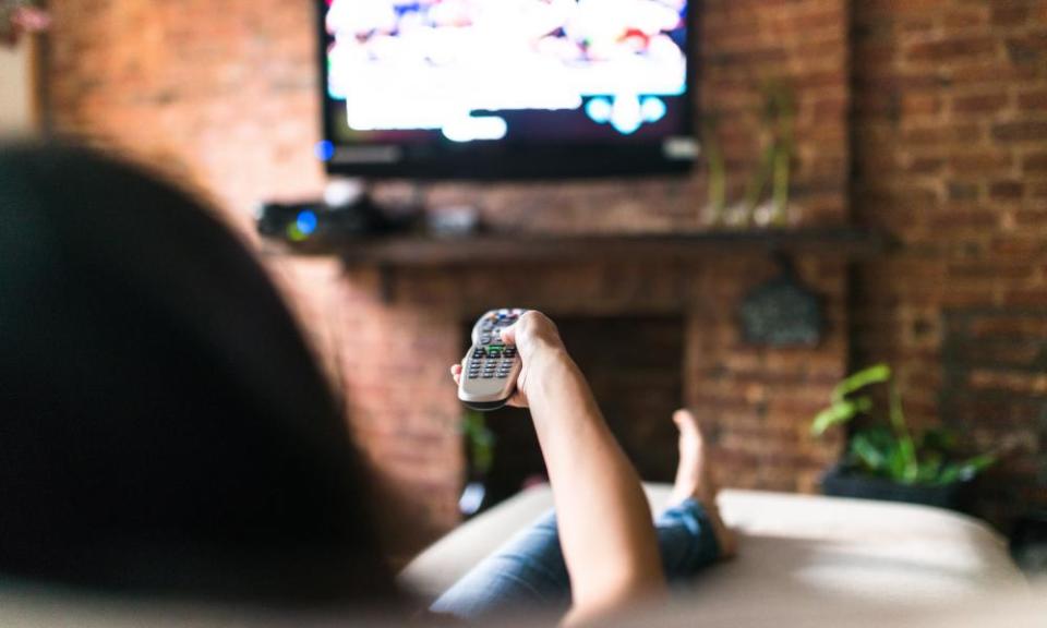 A woman watching TV