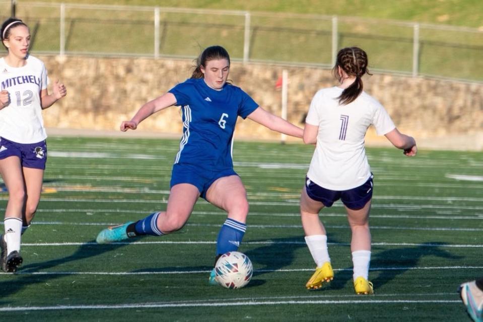Madison High senior Desi Rozeboom crosses a pass to a teammate during a game earlier this season. Rozeboom and the Madison High girls soccer team are 7-0 (5-0 in conference) as of April 5.