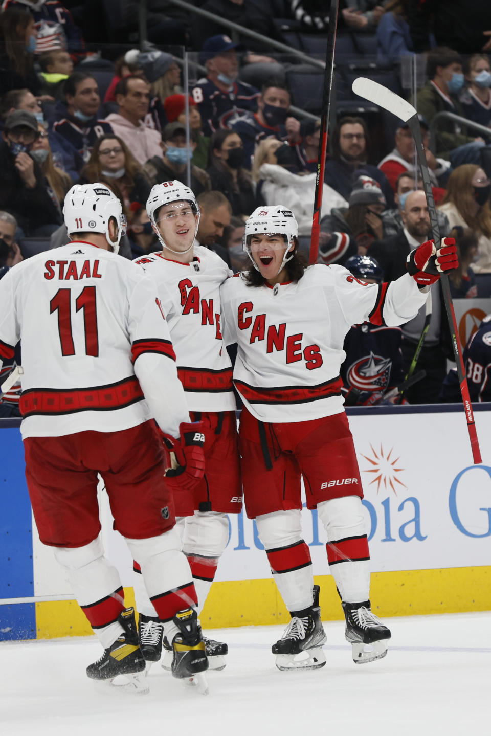 Carolina Hurricanes' Ethan Bear, right, celebrates his goal against the Columbus Blue Jackets with teammates Martin Necas, center, and Jordan Staal during the third period of an NHL hockey game Saturday, Jan. 1, 2022, in Columbus, Ohio. (AP Photo/Jay LaPrete)