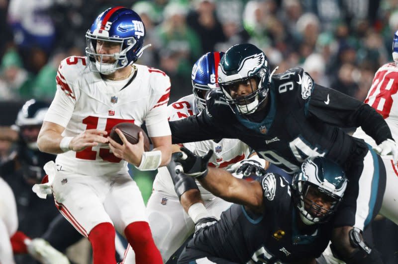 New York Giants quarterback Tommy DeVito (L) is rushed by Philadelphia Eagles defensive end Josh Sweat on Monday at Lincoln Financial Field in Philadelphia. Photo by Laurence Kesterson/UPI