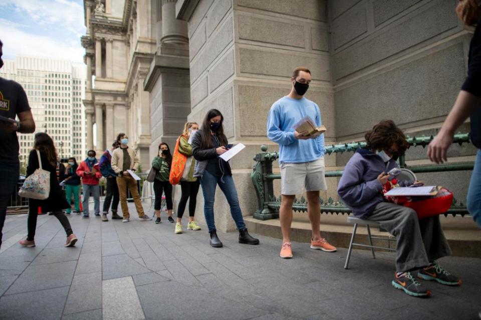 Voters wait in line outside of city hall in Philadelphia, Pennsylvania, on 27 October.