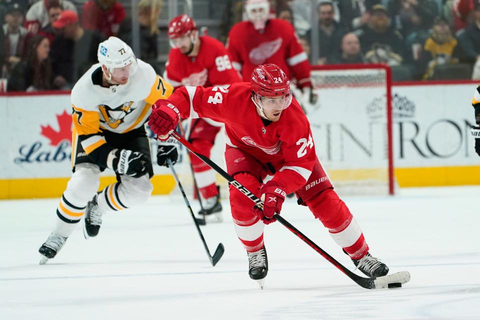 Red Wings center Pius Suter skates with the puck against the Penguins in the first period on Saturday, April 8, 2023, at Little Caesars Arena.