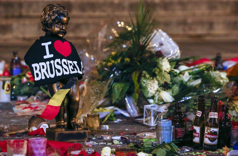 FILE PHOTO: A replica of the Manneken-Pis statue, a major Brussels tourist attraction, is seen among flowers at a memorial for the victims of bomb attacks in Brussels metro and Brussels international airport of Zaventem, in Brussels