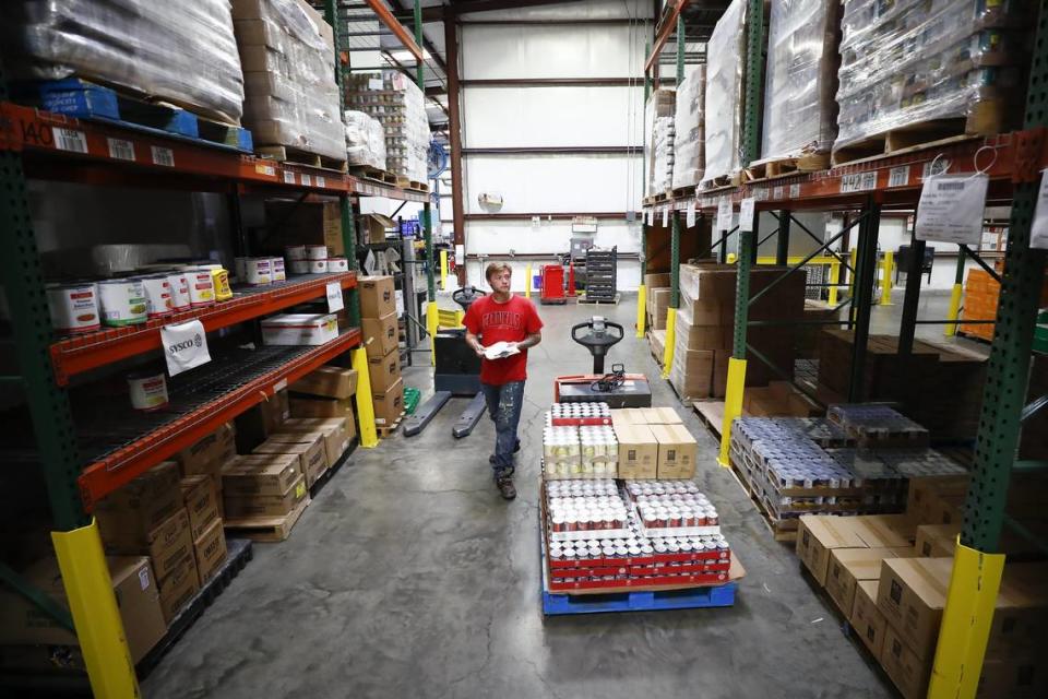 Nick Phillips, of Nicholasville, Ky., loads a pallet of food which will stock the Cambridge Drive location at God’s Pantry Food Bank in Lexington, Ky., Thursday, June 20, 2019.
