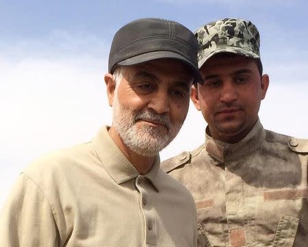 Iranian Revolutionary Guard Commander Qassem Soleimani (L) stands at the frontline during offensive operations against Islamic State militants in the town of Tal Ksaiba in Salahuddin province March 8, 2015. REUTERS/Stringer