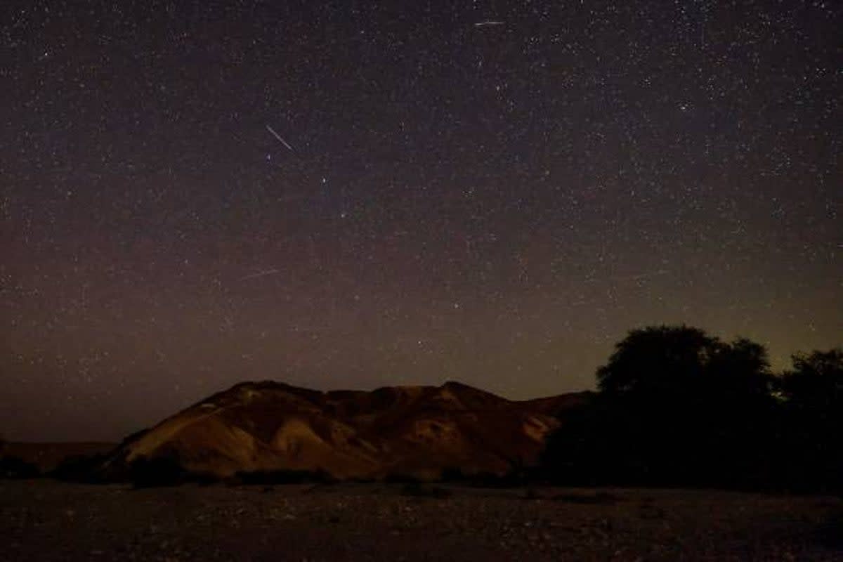 Perseid meteors streaks across the sky above a camping site in the southern israel Negev desert near the Israeli village of Faran early on 12 August 2023 (AFP via Getty Images)