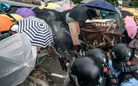  Police officers pepper spray during a clash with anti-extradition protesters - Credit: Getty