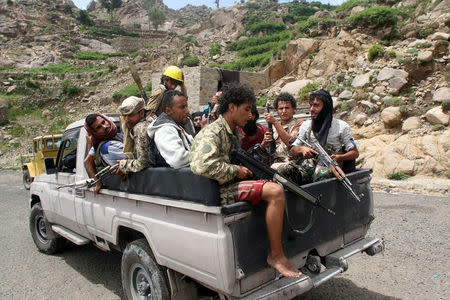 Pro-government fighters ride on the back of a patrol truck in a village taken by pro-government forces from the Iran-allied Houthi militia, in the al-Sarari area of Taiz province, Yemen July 28, 2016. REUTERS/Anees Mahyoub