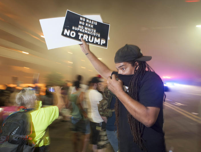 <p>Police use pepper spray to break up protesters gathered outside of the Phoenix, Arizona, Convention Center where US President Donald Trump spoke at a “Make America Great Again” rally on August 22, 2017. (Laura Segall/AFP/Getty Images) </p>