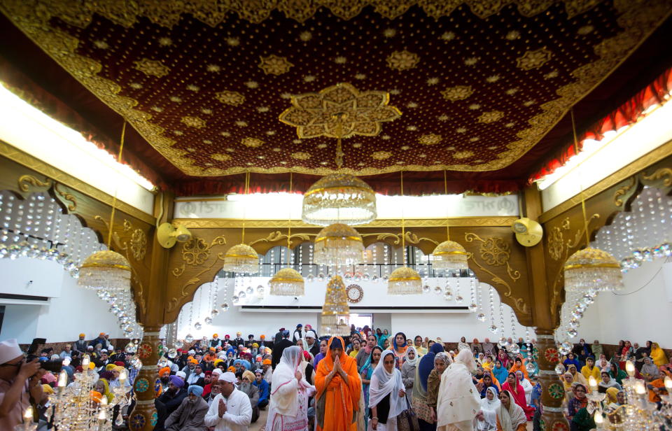 Sikh women and men pray and pay their respects at the Khalsa Diwan Society Sikh Temple before the Vaisakhi parade in Vancouver, B.C., on Saturday April 12, 2014. Vaisakhi is one of the most significant holidays on the Sikh calendar and commemorates the establishment of the Khalsa in 1699. Tens of thousands of people attended the parade and festivities. THE CANADIAN PRESS/Darryl Dyck