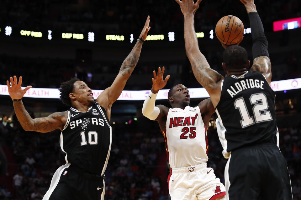 Miami Heat guard Kendrick Nunn shoots the ball against San Antonio Spurs guard DeMar DeRozan and center LaMarcus Aldridge.