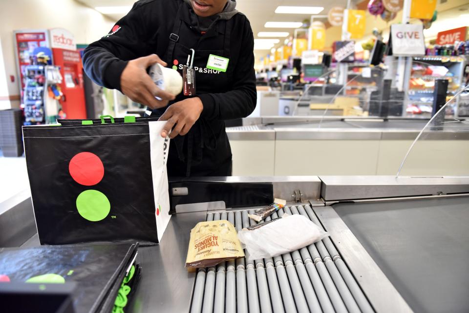 Starliga Darden, a cashier at Stop & Shop in Ridgewood, helps a customer bag their groceries in a reusable bag