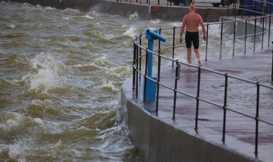 A swimmer braves strong winds and choppy water brought by Storm Lilian in Brighton (REUTERS)