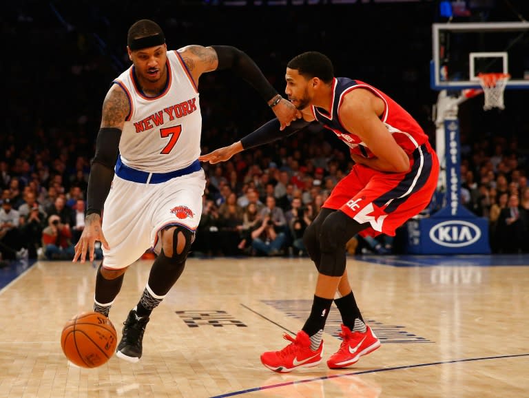 Carmelo Anthony of the New York Knicks drives against Garrett Temple of the Washington Wizards during their game at Madison Square Garden on February 9, 2016 in New York City