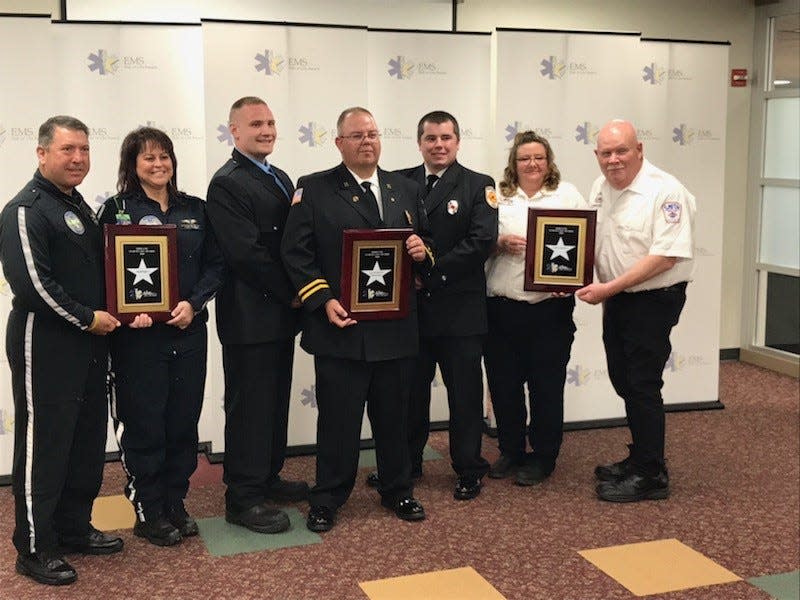 Honored Wednesday for their care of a woman who had been kicked by a horse were (left to right) Herman Valentine, MedFlight 4 pilot; Michelle Huff, MedFight 4 paramedic; Curtis McGarry, Uhrichsville Fire Department firefighter/paramedic; Capt. Nathan Crouse, Uhrichsville firefighter/paramedic; Cory Paisley, Uhrichsville firefighter/paramedic; Charissa Cunningham, Smith Ambulance advanced emergency medical technician and Jay Fisher, Smith Ambulance paramedic. They received the Ohio EMS Star of Life Award in Columbus.