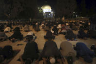 Muslim men pray next to the Dome of the Rock Mosque in the Al Aqsa Mosque compound in Jerusalem's old city, Sunday, May 31, 2020.The Al-Aqsa mosque in Jerusalem, the third holiest site in Islam, reopened early Sunday, following weeks of closure aimed at preventing the spread of the coronavirus. (AP Photo/Mahmoud Illean)