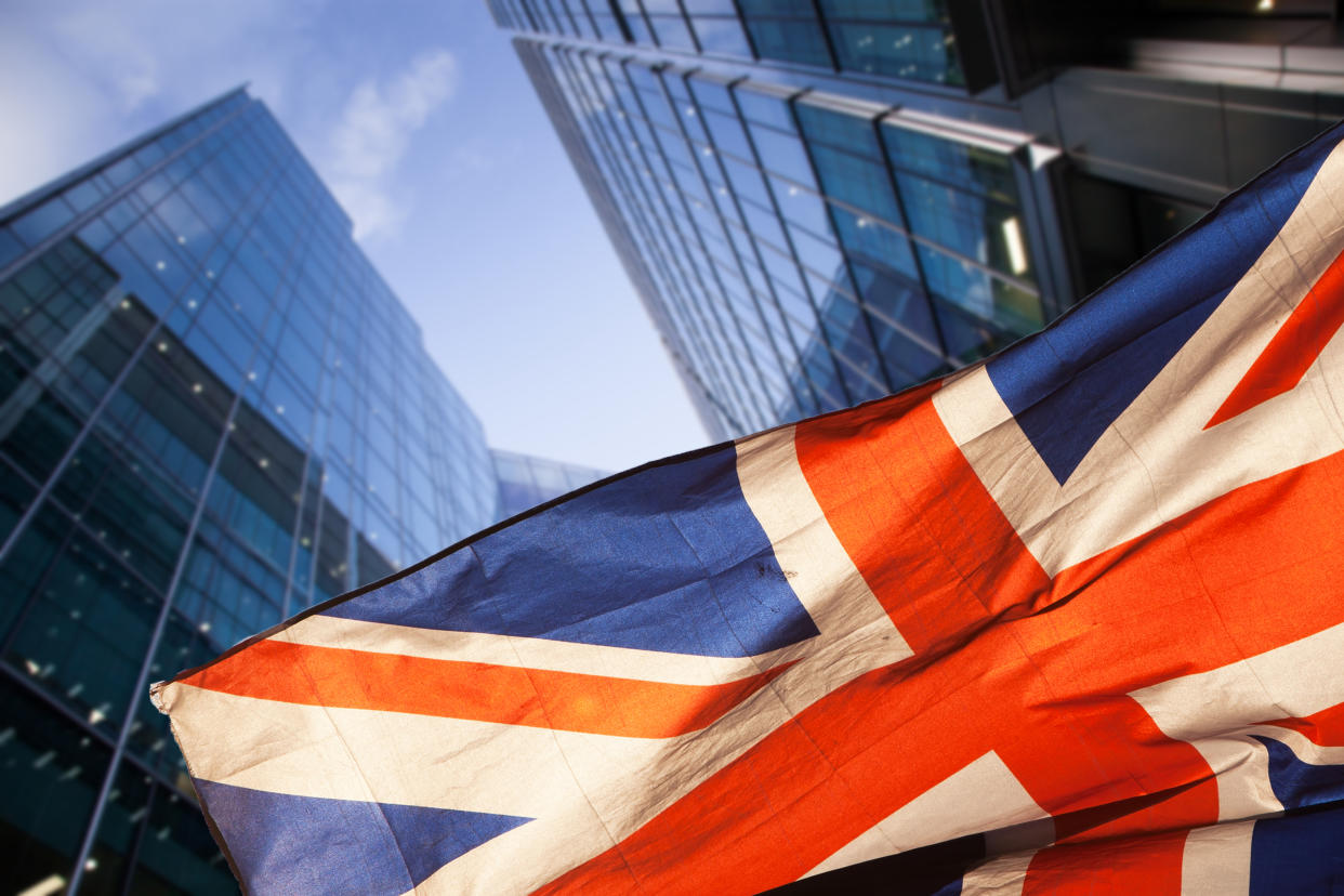 brexit concept - UK economy after Brexit deal - double exposure of flag and Canary Wharf business center skyscrapers