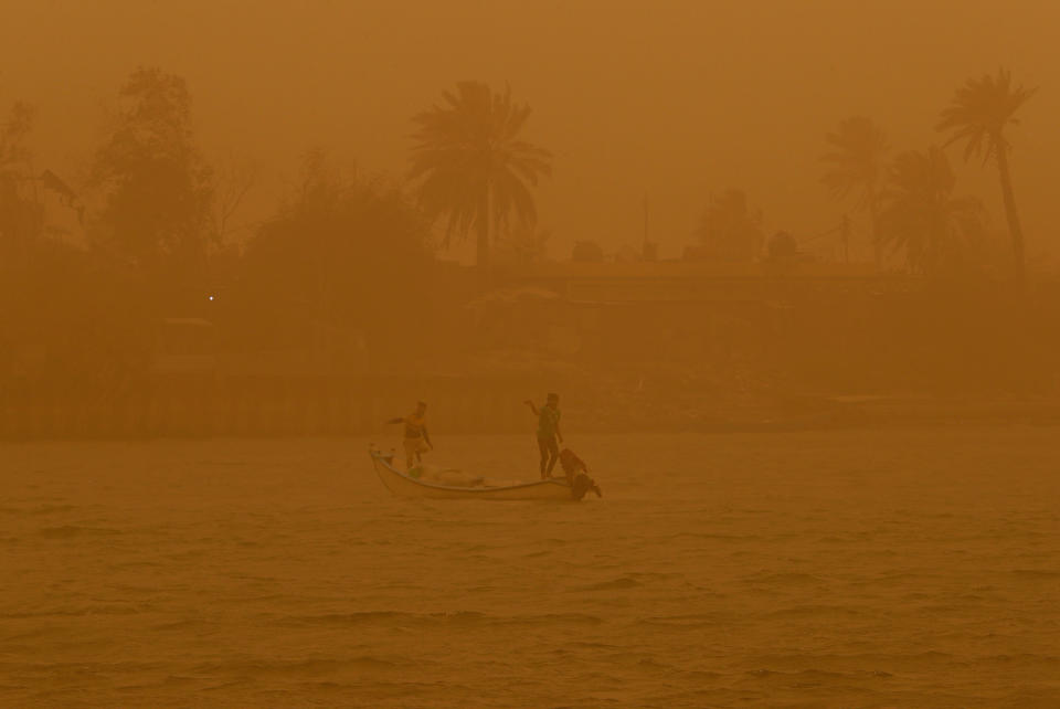 FILE - Fishermen navigate on the Shatt al-Arab waterway during a sandstorm in Basra, Iraq, May 23, 2022. The Middle East is one of the most vulnerable regions in the world to the impact of climate change, and already the effects are being seen. This year's annual U.N. climate change conference, known as COP27, is being held in Egypt in November, throwing a spotlight on the region. (AP Photo/Nabil al-Jurani, File)