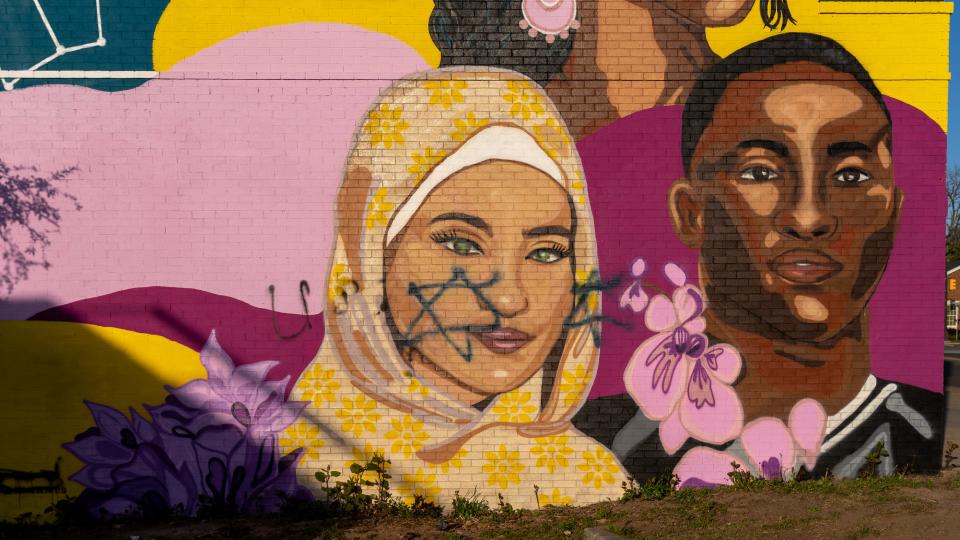 A new mural, "Home Is Where We Make It," was installed less than 48 hours before it was defaced twice on April 30, and residents are outraged.