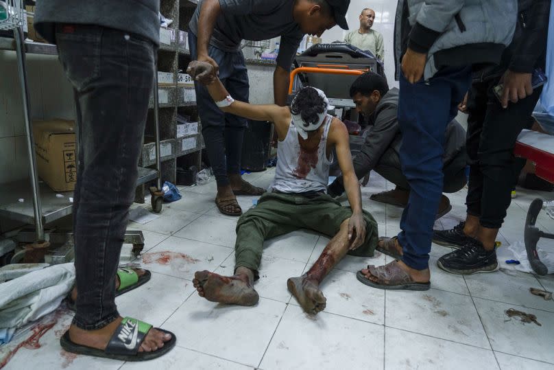 A Palestinian man wounded in Israeli bombardment of the Gaza Strip is treated in a hospital in Khan Younis, Sunday, Dec. 3, 2023.