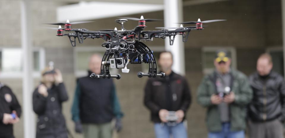 In this Feb. 13, 2014, photo, members of the Box Elder County Sheriff's Office search and rescue team fly their search and rescue drone during a demonstration, in Brigham City, Utah. Law enforcement, government agencies and others are itching to use drones for everything from finding lost hikers to tracking shifting wildfires. But privacy watchdogs are urging state legislatures to step in and head off any potential privacy violations. That tension is on display as more than 35 states consider drone legislation this year, according to the National Conference of State Legislatures. The bills include ways to attract an industry that could generate billions and restrictions on drone use and data collection. (AP Photo/Rick Bowmer)