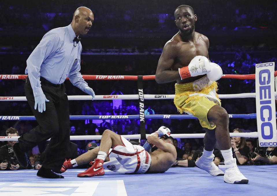 Terence Crawford, right, reacts after knocking down England's Amir Khan during the first round of a WBO world welterweight championship boxing match Sunday, April 21, 2019, in New York. Crawford won the fight. (AP Photo/Frank Franklin II)