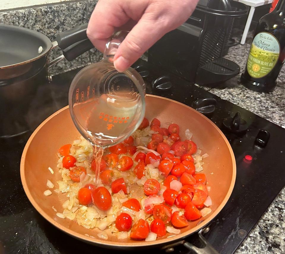 Adding white wine to pan for Gordon Ramsay's 10-minute scampi