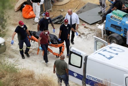 Members of Cyprus Special Disaster Response Unit carry a body near the village of Mitsero