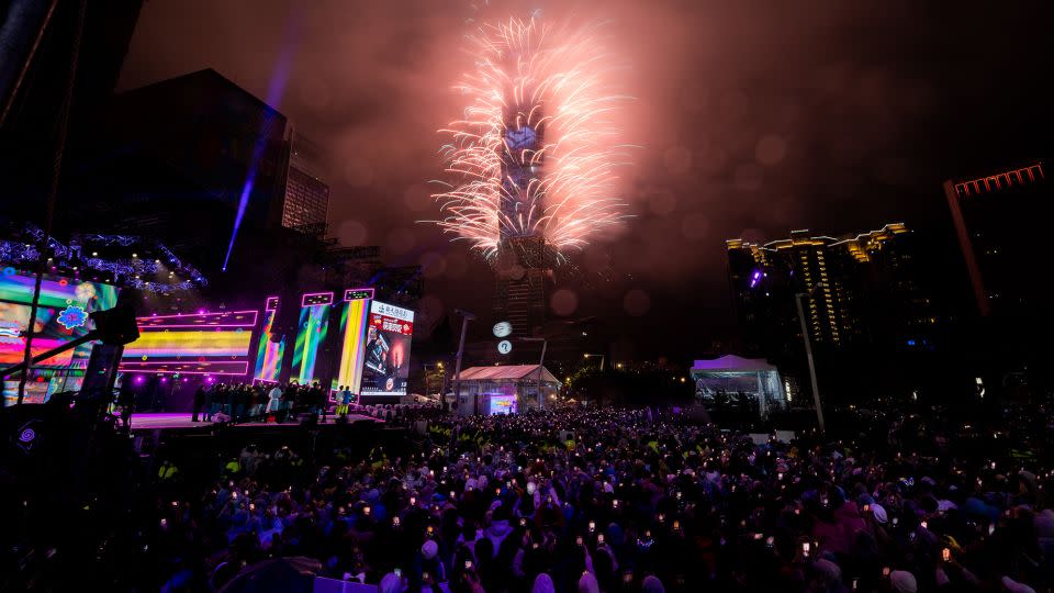 People celebrate as fireworks light up the skyline from the Taipei 101 building during New Year's celebrations on January 1, 2023, in Taipei, Taiwan. - Gene Wang/Getty Images