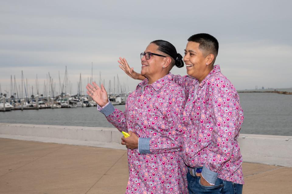 Jennifer Rincon, left, and Jennifer Ruiz wave at floats during the Pride Parade on Saturday, Oct. 7, 2023, in Corpus Christi, Texas.