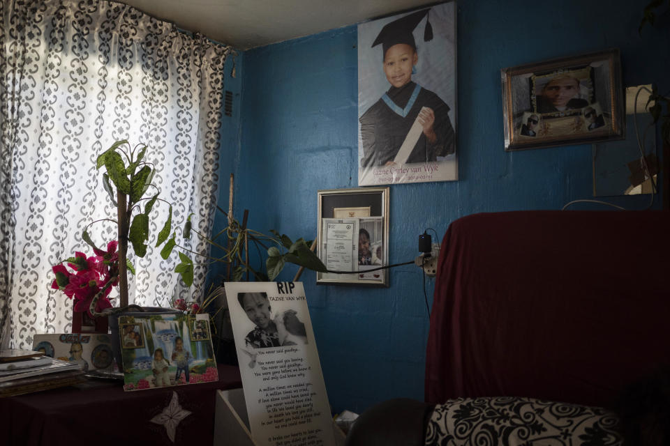 Photos of 8-year-old Tazne van Wyk hang inside her parents' house in Cape Town, South Africa, on Sept. 10, 2020. The girl's body was found in February dumped in a drain near a highway, nearly two weeks after she disappeared. Police said she had been abducted, raped and murdered. (AP Photo/Bram Janssen)