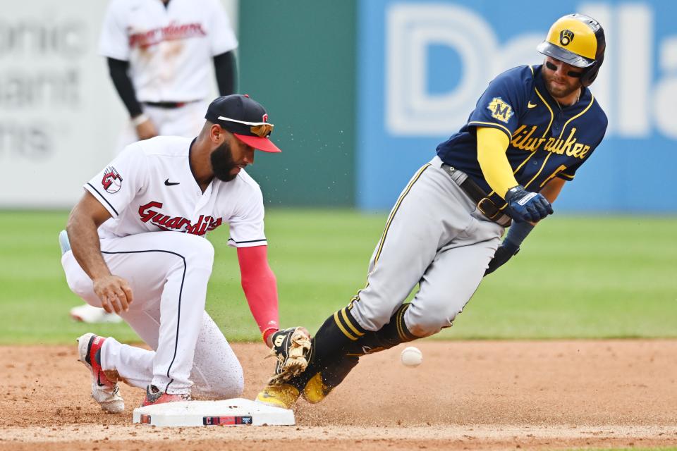 Brewers infielder Owen Miller slides safely into second with an RBI double in the third inning as the ball gets away from Guardians shortstop Amed Rosario on Sunday at Progressive Field.