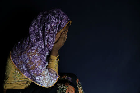 Begum, a Rohingya rape victim, hides her face as she poses in Teknaf, Bangladesh, June 25, 2018. REUTERS/Mohammad Ponir Hossain