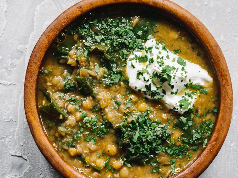 lentil soup in a wooden bowl with sour cream