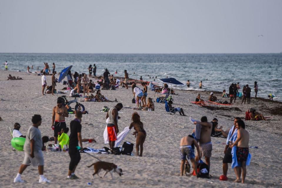 People relax on the beach in Miami Beach, Florida.