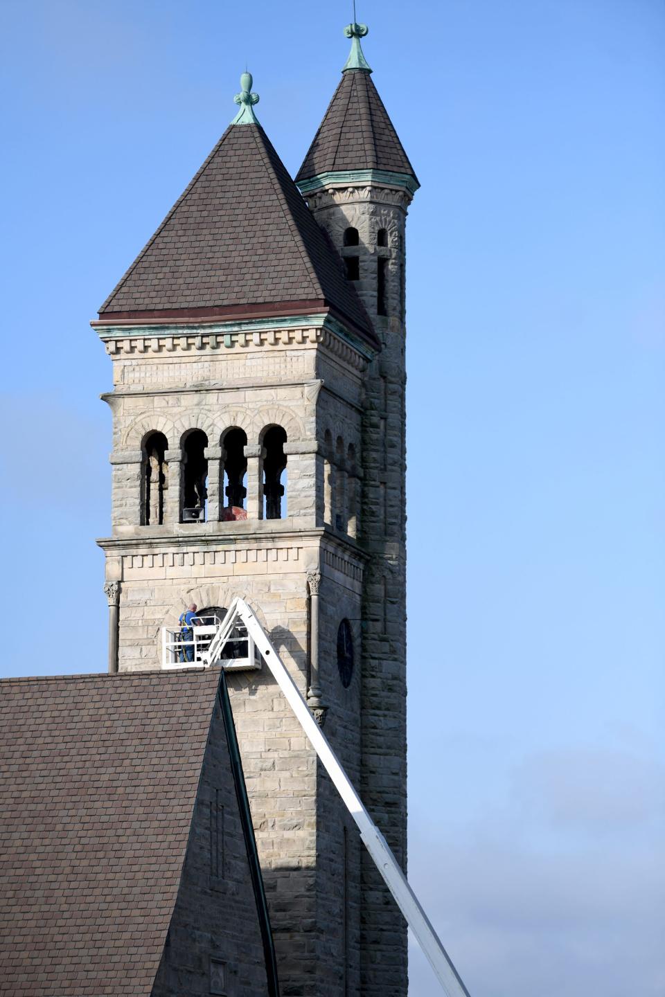 Workers change out the iconic town clock at First United Methodist Church in Massillon. The clock has watched over downtown since the 1800s.