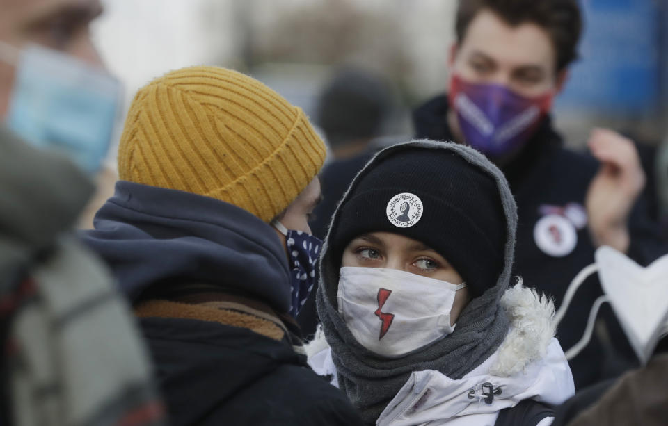 A protestor wears a lightning bolt face mask during a protest on International Women's Day, in Warsaw, Poland, Monday March 8, 2021. Women’s rights activists in Poland marked International Women’s Day on Monday caught between reasons to celebrate and a heavy sense that they are facing a long battle ahead. This year’s Women’s Day, which is being marked with protests, comes after a near total ban on abortion took effect in January in the historically Roman Catholic country, a step that had long been been sought by the conservative ruling party, Law and Justice. (AP Photo/Czarek Sokolowski)