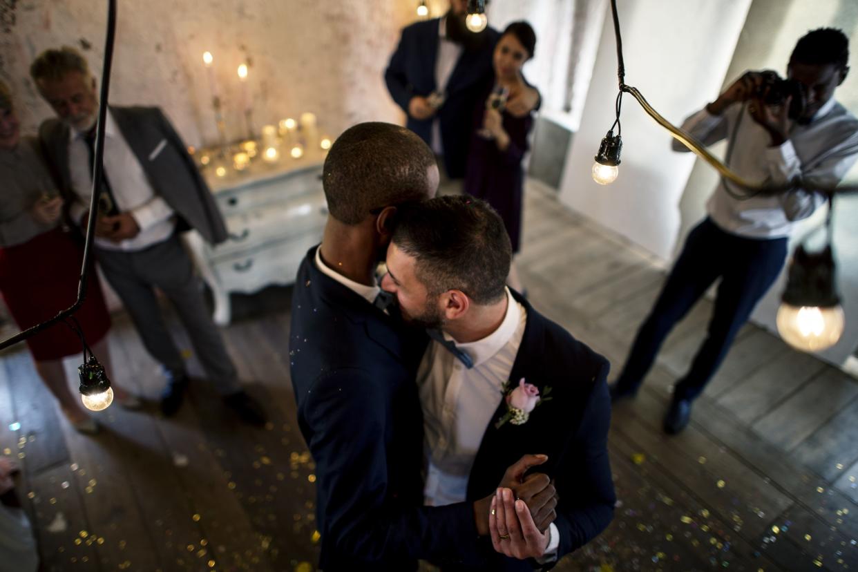 newlywed gay couple dancing on wedding celebration 