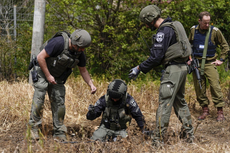 Israeli security forces examine the site hit by a rocket fired from Lebanon, in Kiryat Shmona, northern Israel, Wednesday, March 27, 2024. Israel Rescue Services said that one person was killed and two others lightly injured in a Hezbollah rocket attack on northern Israel. The man, aged 25, was killed from a fire that broke out at a factory in an industrial park in the northern city of Kiryat Shmona as a result of a direct hit. (AP Photo/Ariel Schalit)