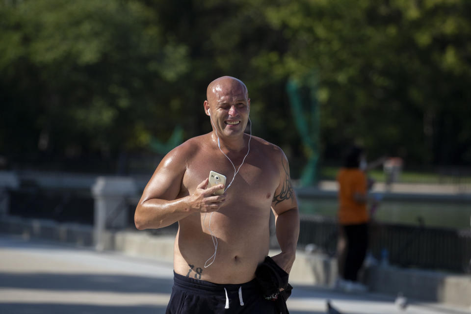 A man jogs during a hot day of summer at the Retiro park in Madrid, Spain, Wednesday, July 29, 2020. The first heat wave of the summer, which will arrive this Thursday and will last at least until next Saturday will leave temperatures over 34 Celsius (104 Fahrenheit). (AP Photo/Manu Fernandez)