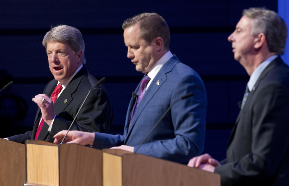 Republican gubernatorial candidates State Sen. Frank Wagner, left, gestures as Corey Stewart, center, and Ed Gillespie, right, listen during a debate at Liberty University in Lynchburg, Va., Thursday, April 13, 2017. (AP Photo/Steve Helber)'