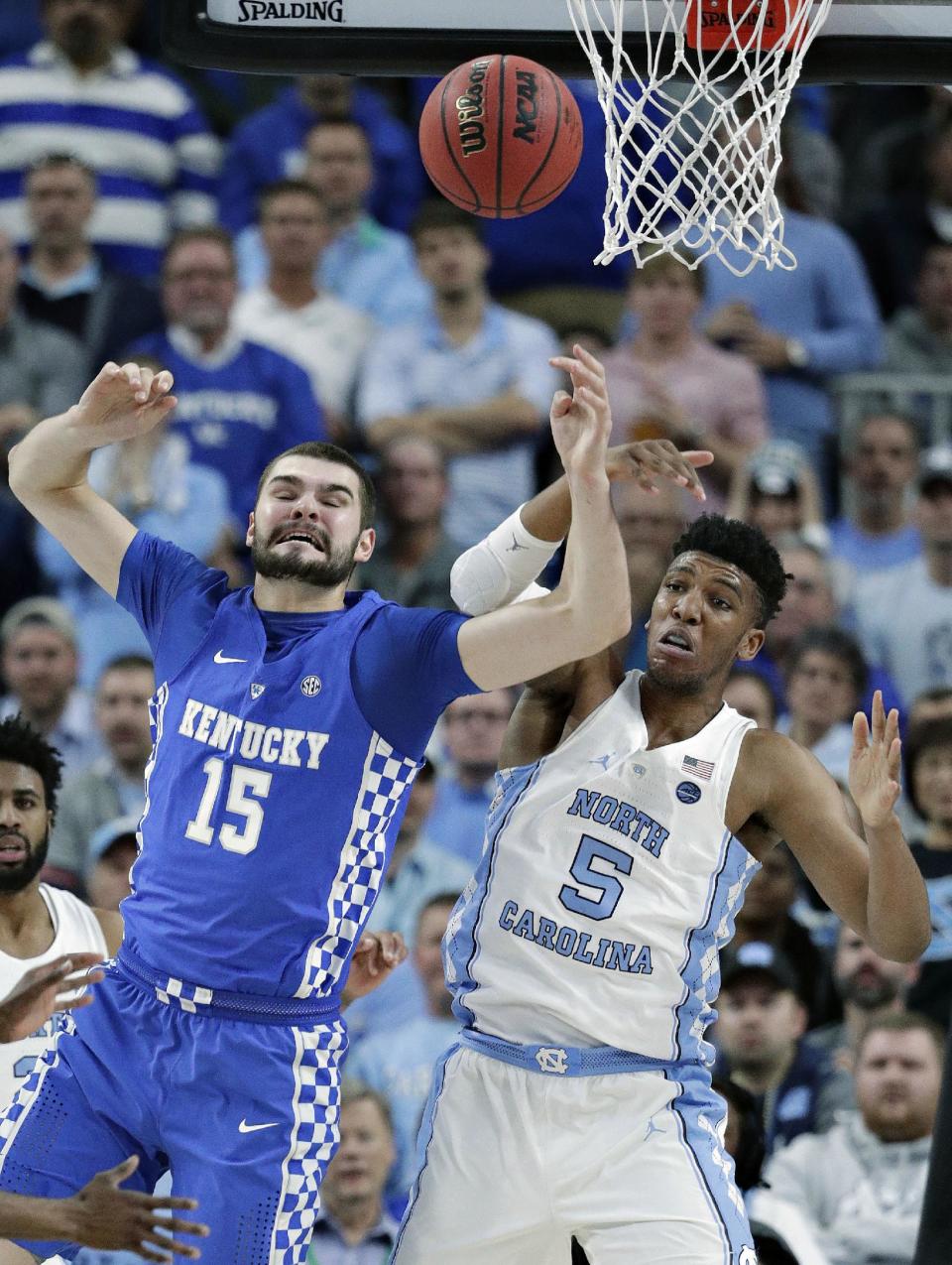 Kentucky's Isaac Humphries (15) and North Carolina's Tony Bradley (5) battle for a rebound during the first half of an NCAA college basketball game Saturday, Dec. 17, 2016, in Las Vegas. (AP Photo/John Locher)