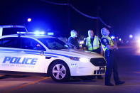 Authorities direct traffic on Hoffmeyer Road near the Vintage Place neighborhood where several law enforcement officers were shot, one fatally, Wednesday, Oct. 3, 2018, in Florence, S.C. (AP Photo/Sean Rayford)